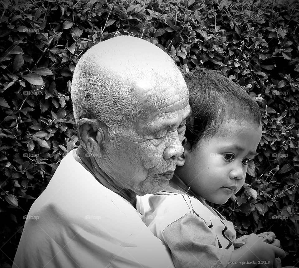 Close-up of a grandchild with his grandfather