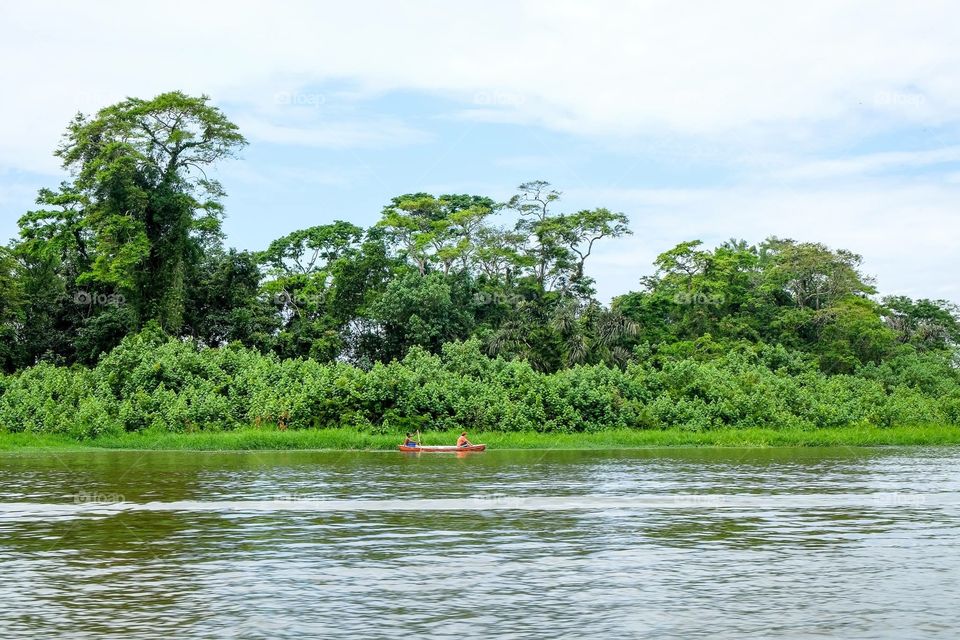 A boat in the jungle. A boat with two man in a river in the jungle of Costa Rica