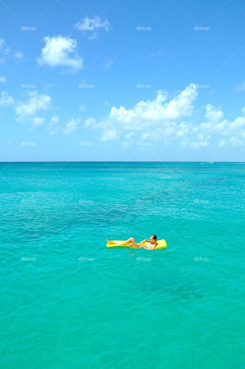 Girl in floating airbed, caribbean