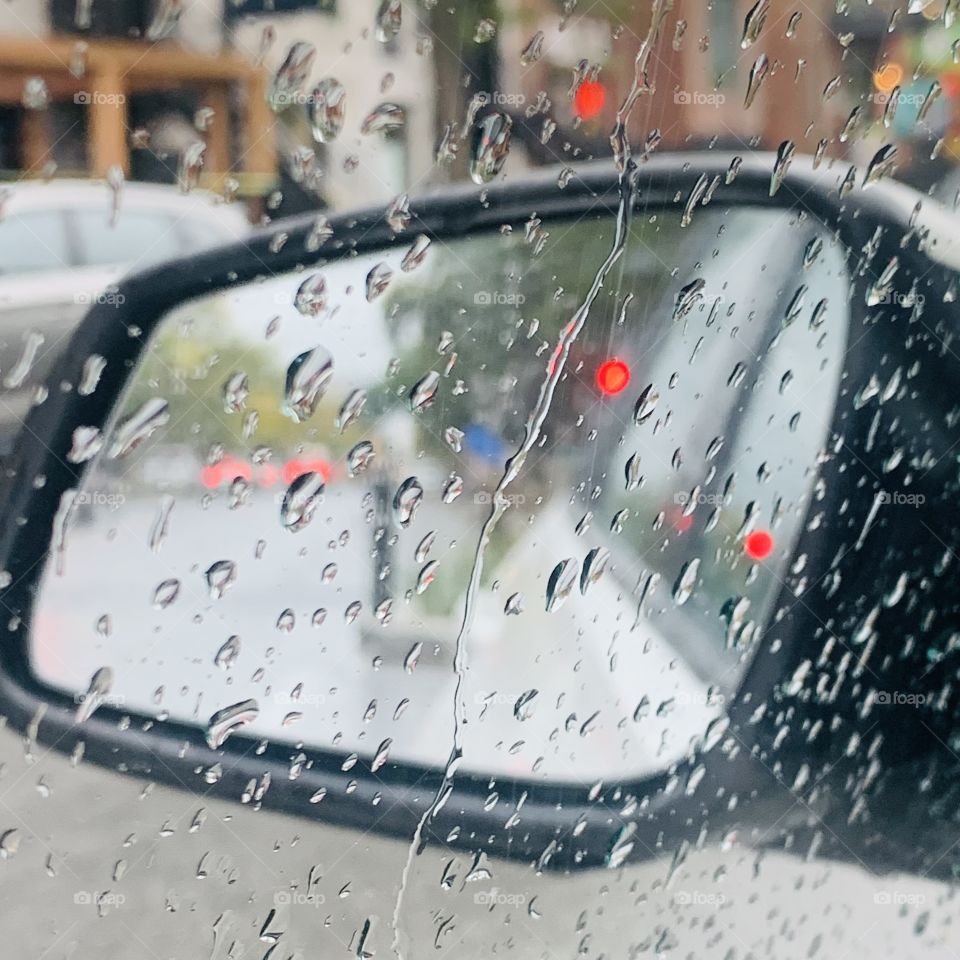 Sitting in my car looking in my mirror on a rainy day on St.Denis Street, Montreal, Quebec, Canada 
