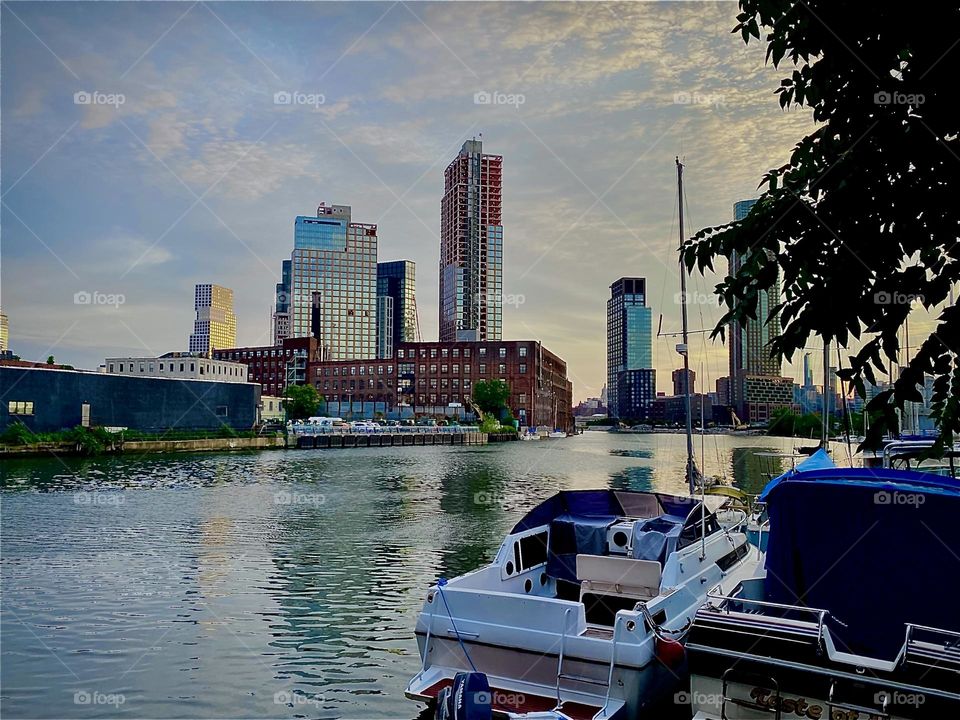 The “East River” at “Newtown Creek” seen from the parking lot underneath the “Pulaski Bridge” on a balmy early summer evening just before twilight time. 2022. Hypnotic Productions