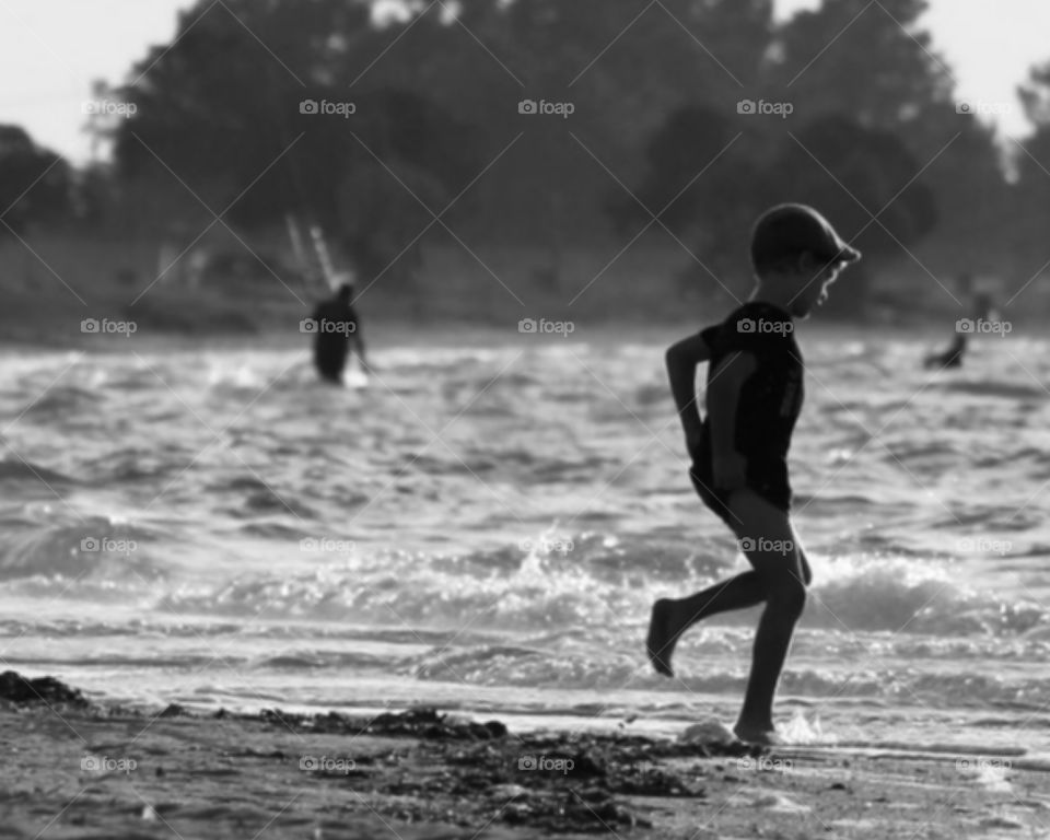 Child Playing and Running on the Beach 