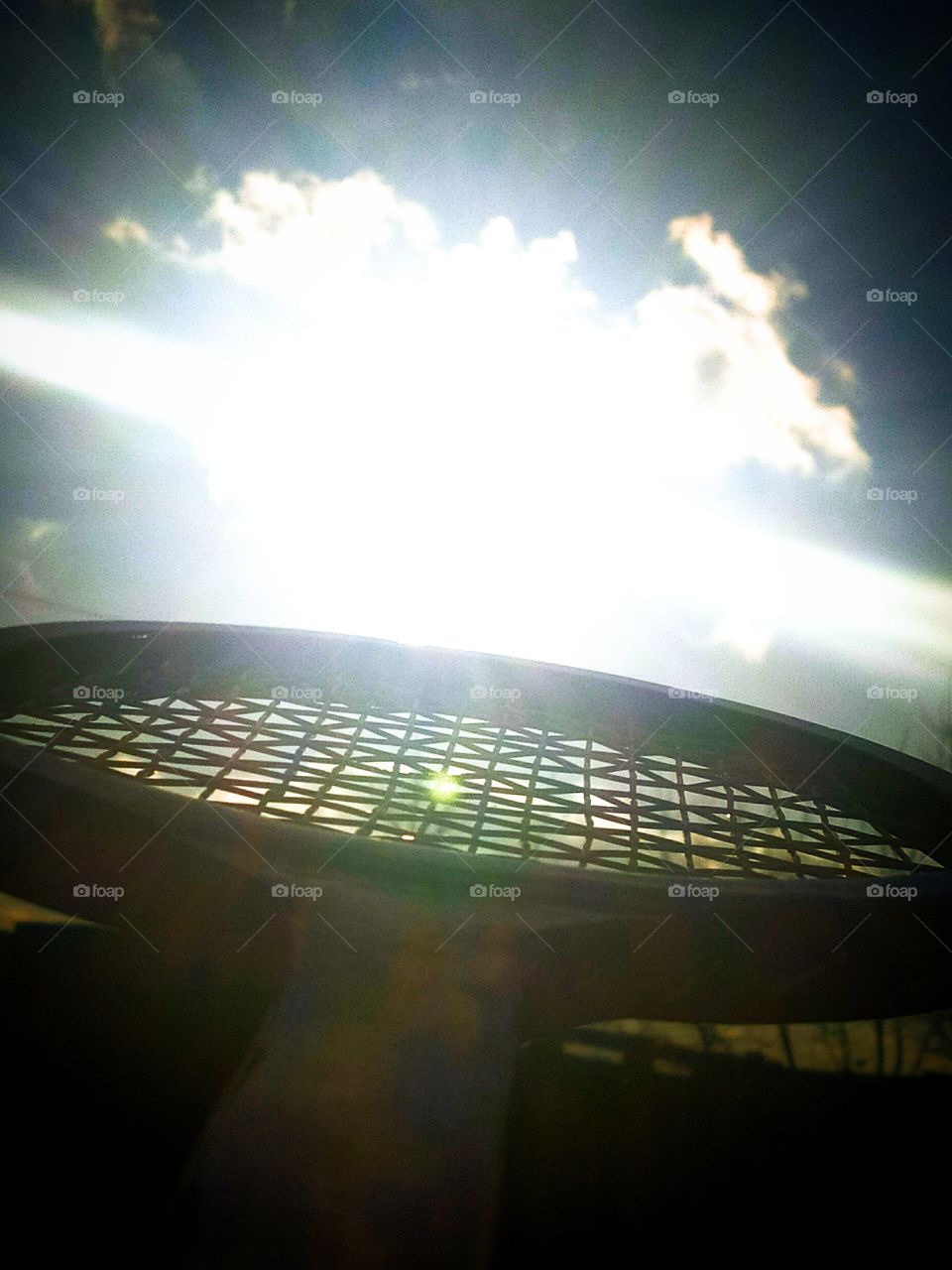 Sun on a tennis racket