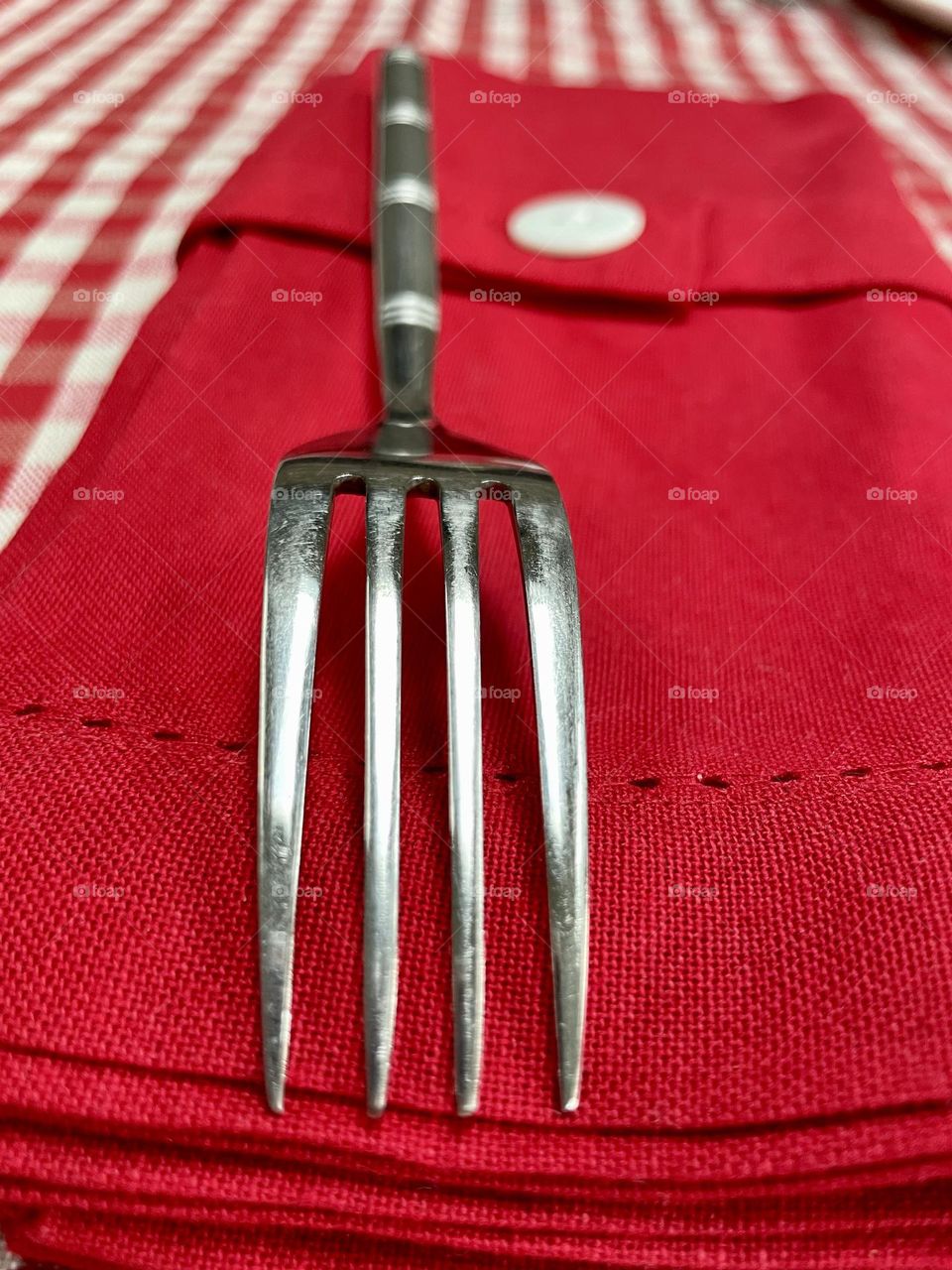 Fork upturned in a red napkin 