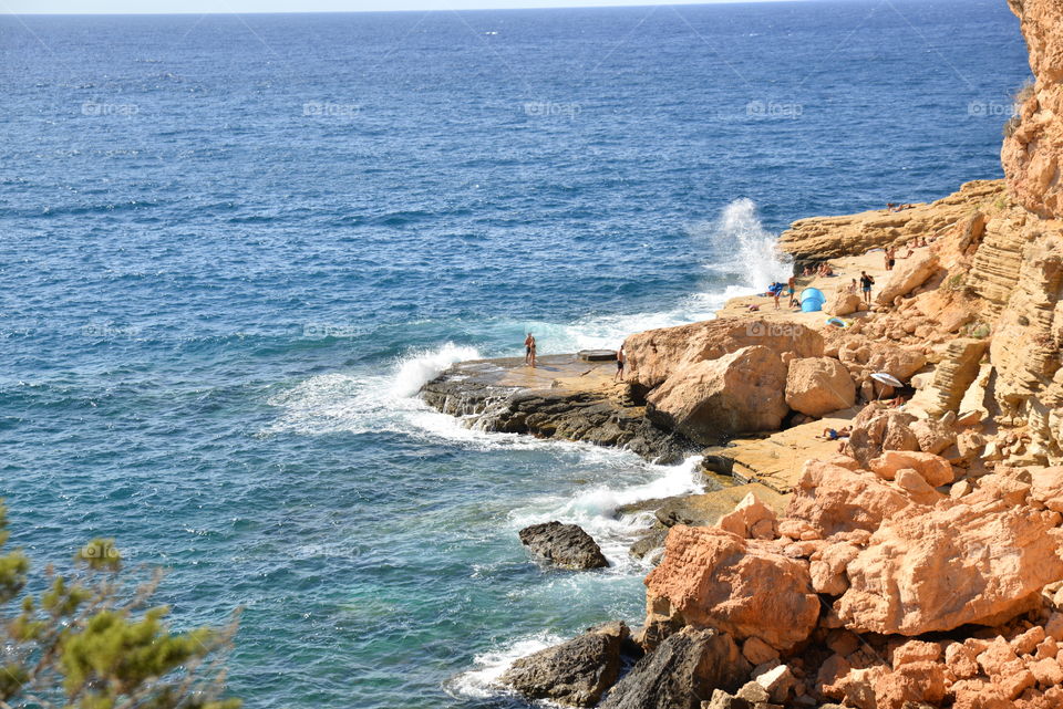Waves splashing against rocks at ibiza