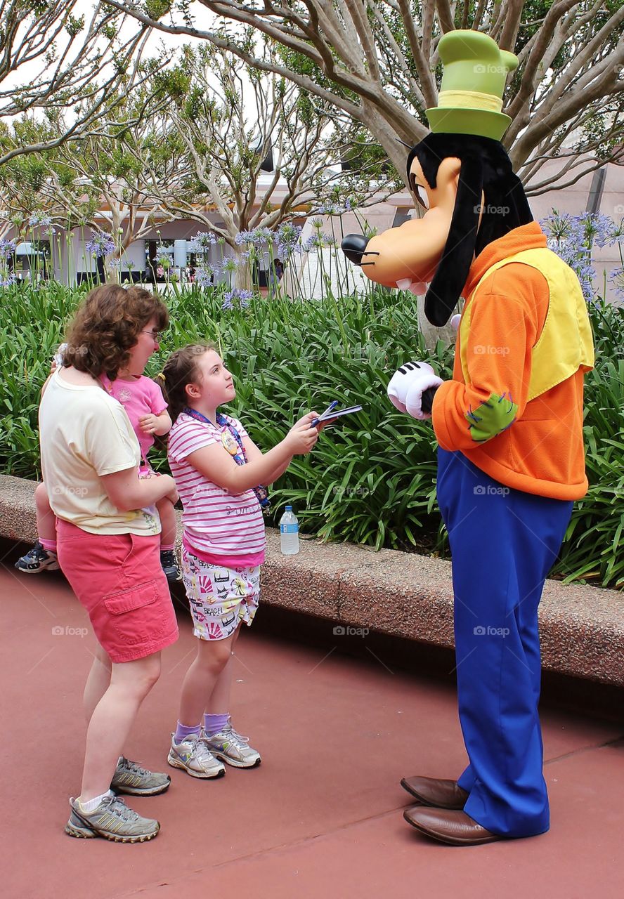 Autograph, please?. Mom supplies some courage to her daughter in approaching Goofy for an autograph - mother and daughter mission 