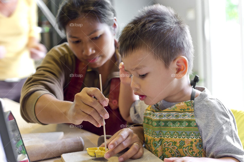 team work mother and son doing handmade ceramics . model Thitiwin Dupont and Sriwan 