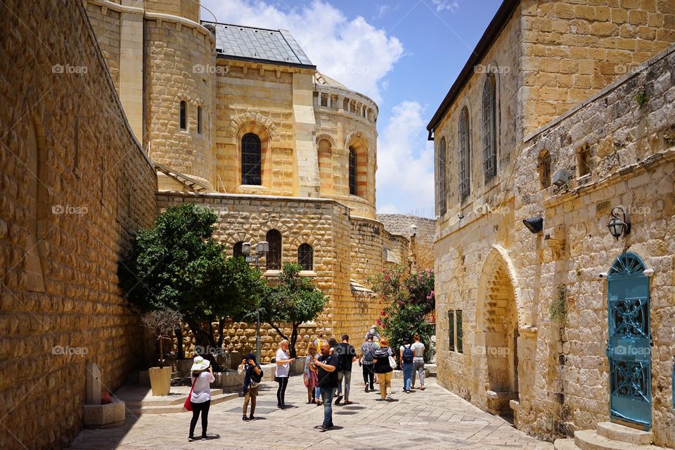 group of tourists in a corner of old buildings inside the Jerusalem of Israel
