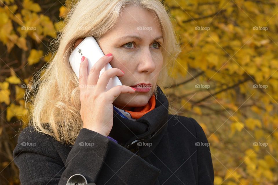 woman with smartphone, autumn time, outside