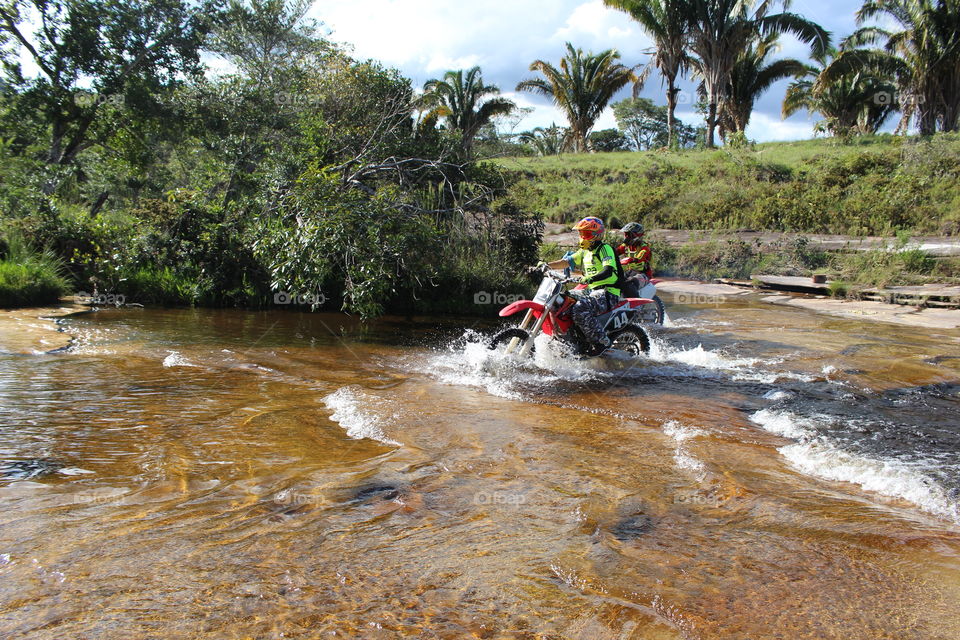 Bikers doing trail in waterfall