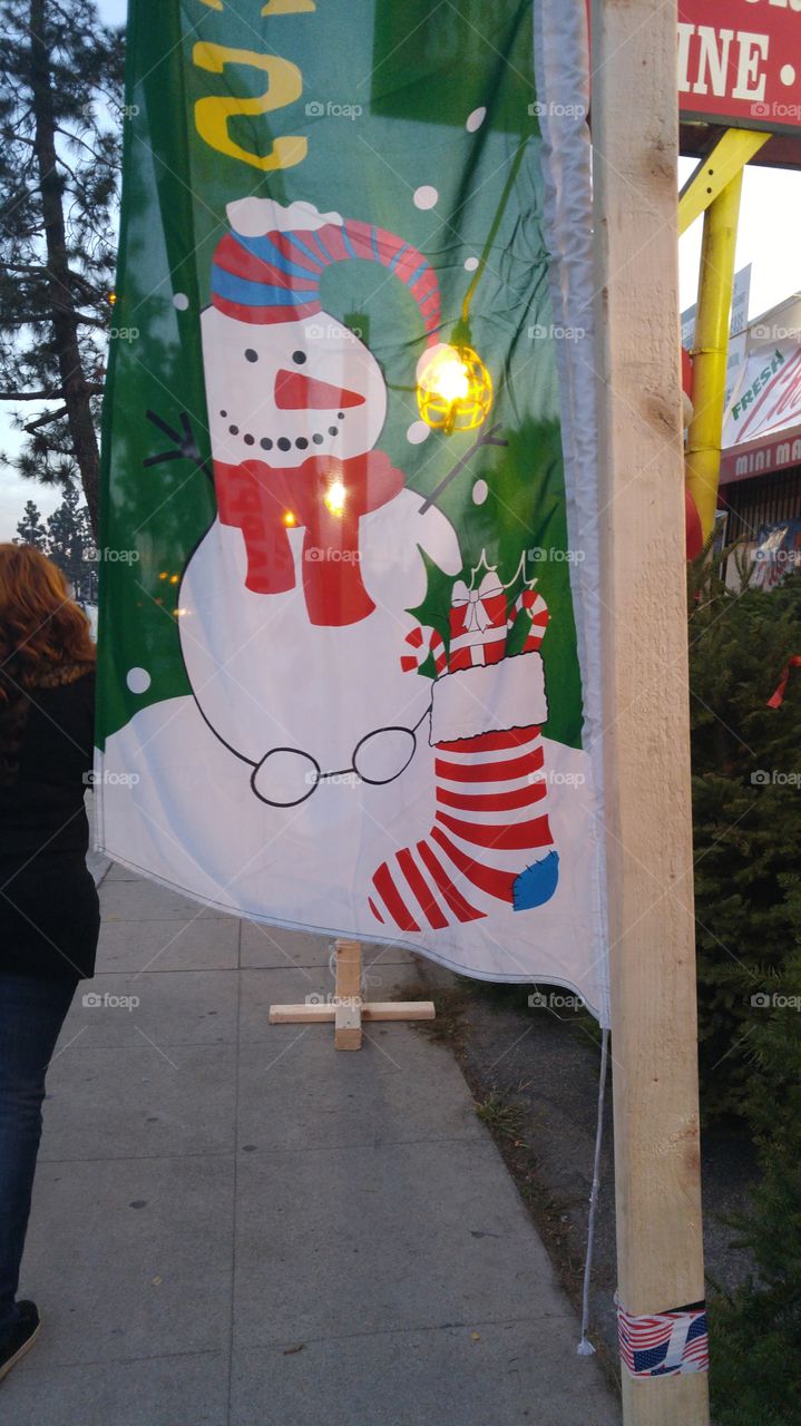 Christmas Tree Sign with Snowman on it.
