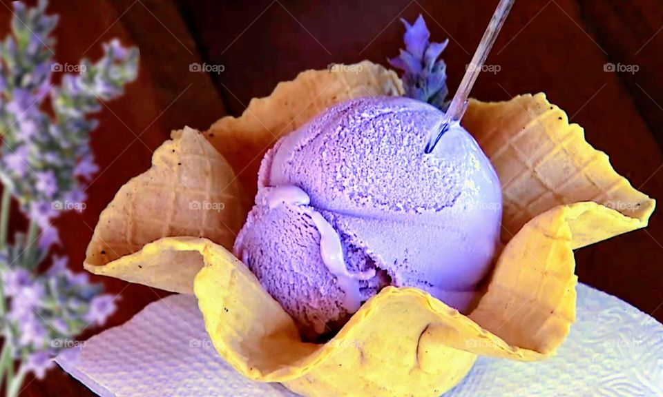 Lavender ice cream in a yellow cone