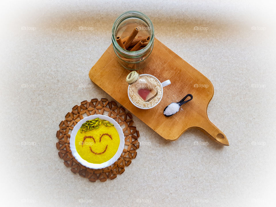 creating a delicious happy little dessert. sholezard, with the ingredients sugar, rice, cinnamon, saffron and some pistachios on top. I just love this dessert, decorating the top before eating it, is half the fun