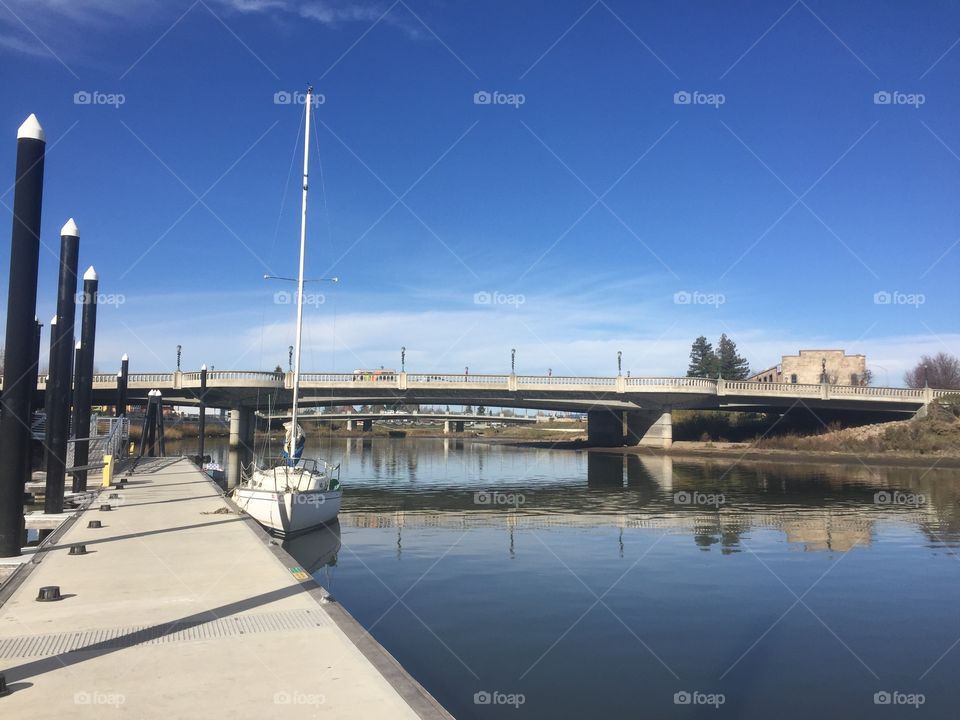 A boat is docked on the Napa River. 