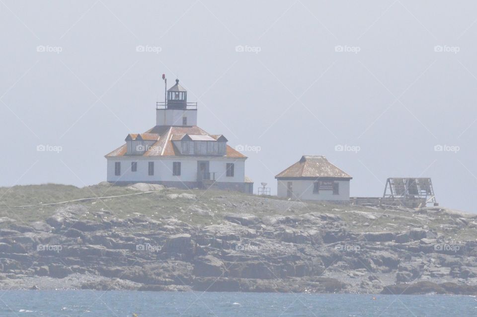 Maine Lighthouse in the early morning fog 