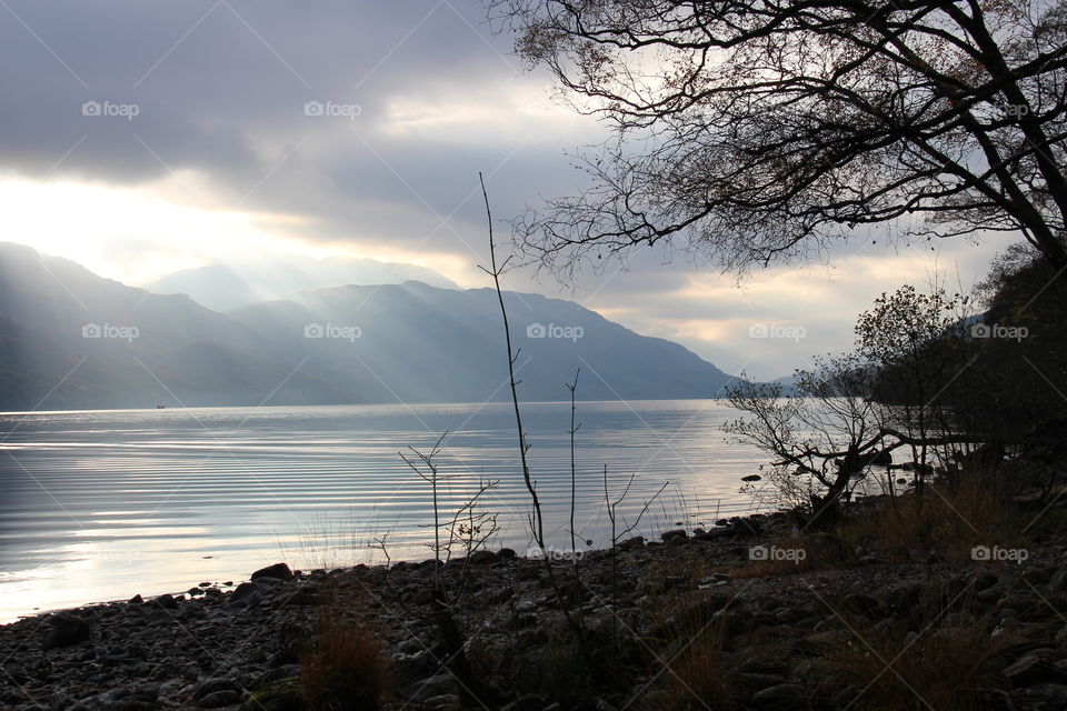 Sun beams coming through clouds over Loch Lomond 