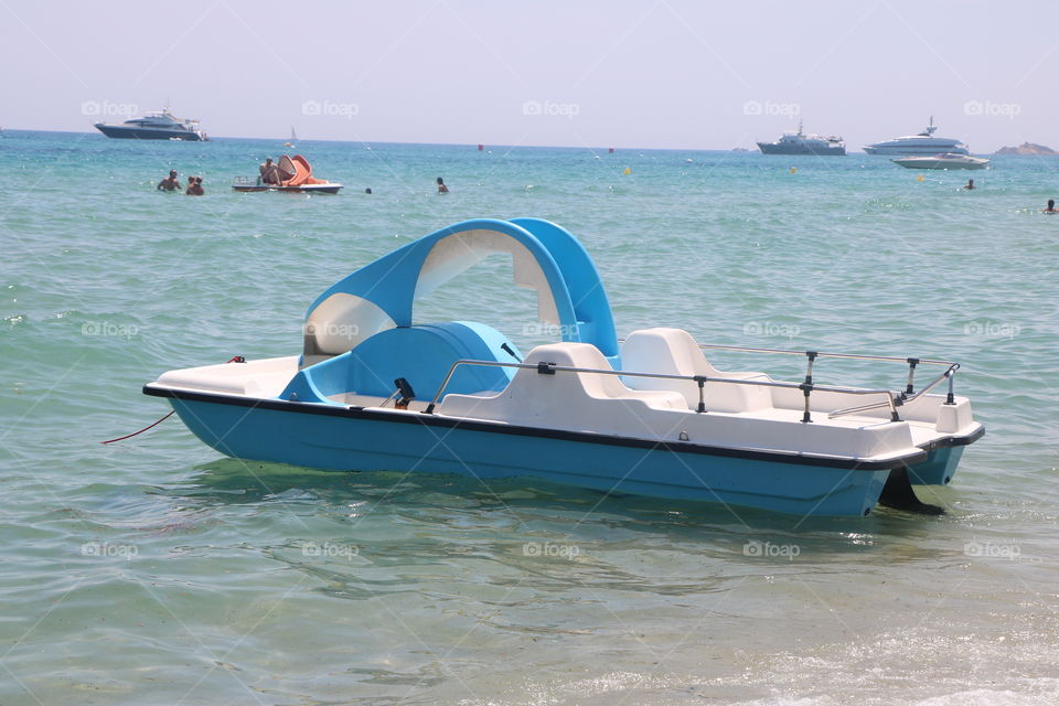 Blue boat in the azur sea