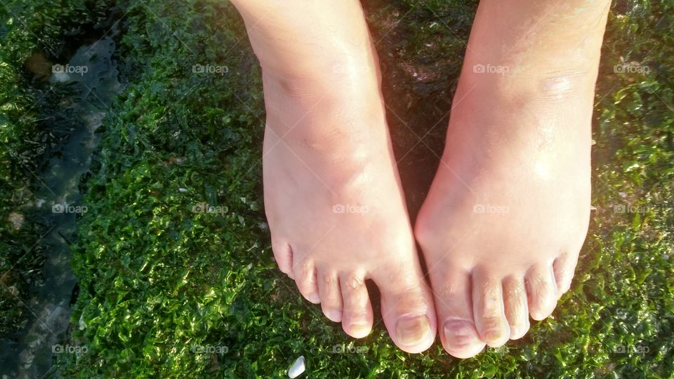 my feet on a green grass.