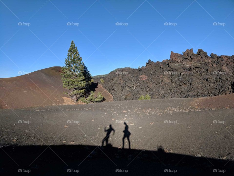 Two Shadows (Silhouettes) Walking on a Ridge of Volcanic Ash during a Hike at Cinder Cone in California