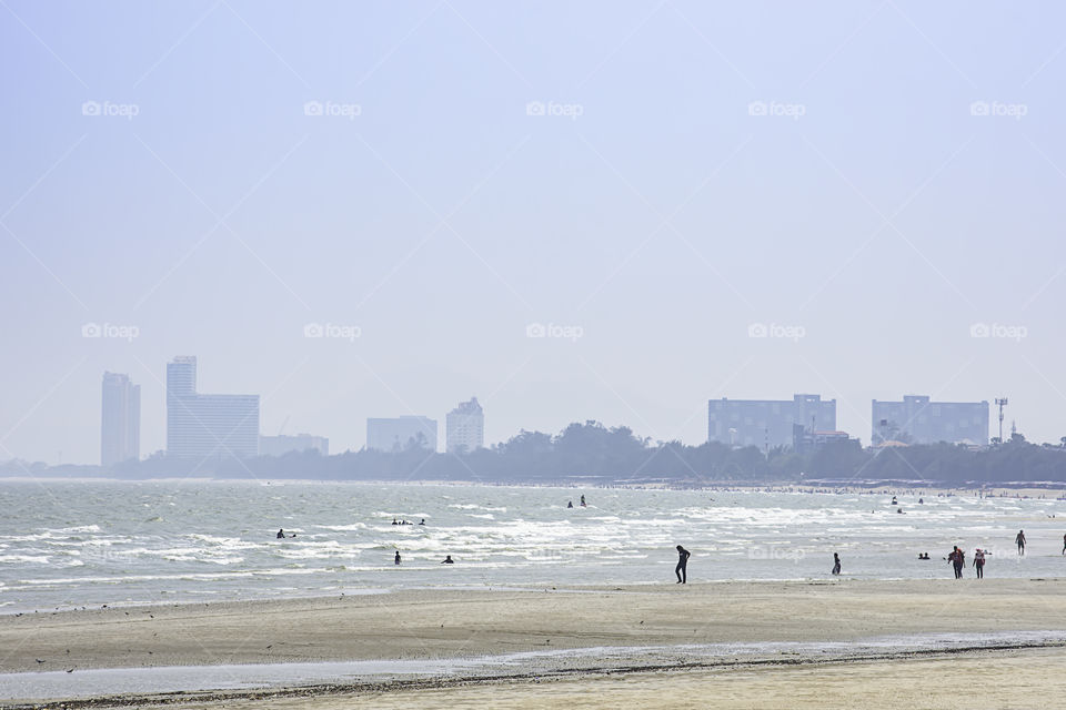 The tourists on the beach in the holidays at Cha am beach. Petchaburi in Thailand. March 24, 2019