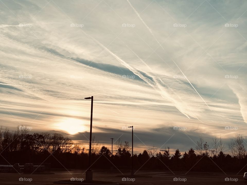 Sunset over the local city, on a chilly Autumn evening. The tree line, the jet trails, the wispy clouds.. it’s just stunning. 
