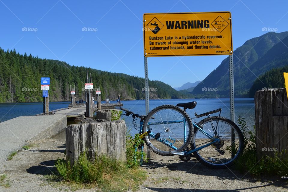 Me and my bike fishing. A bike ride to the lake to fish, bike securely locked in view of lake and fishing dock, rider fishing at dock