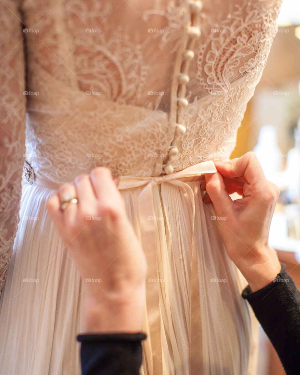 Woman helping bride