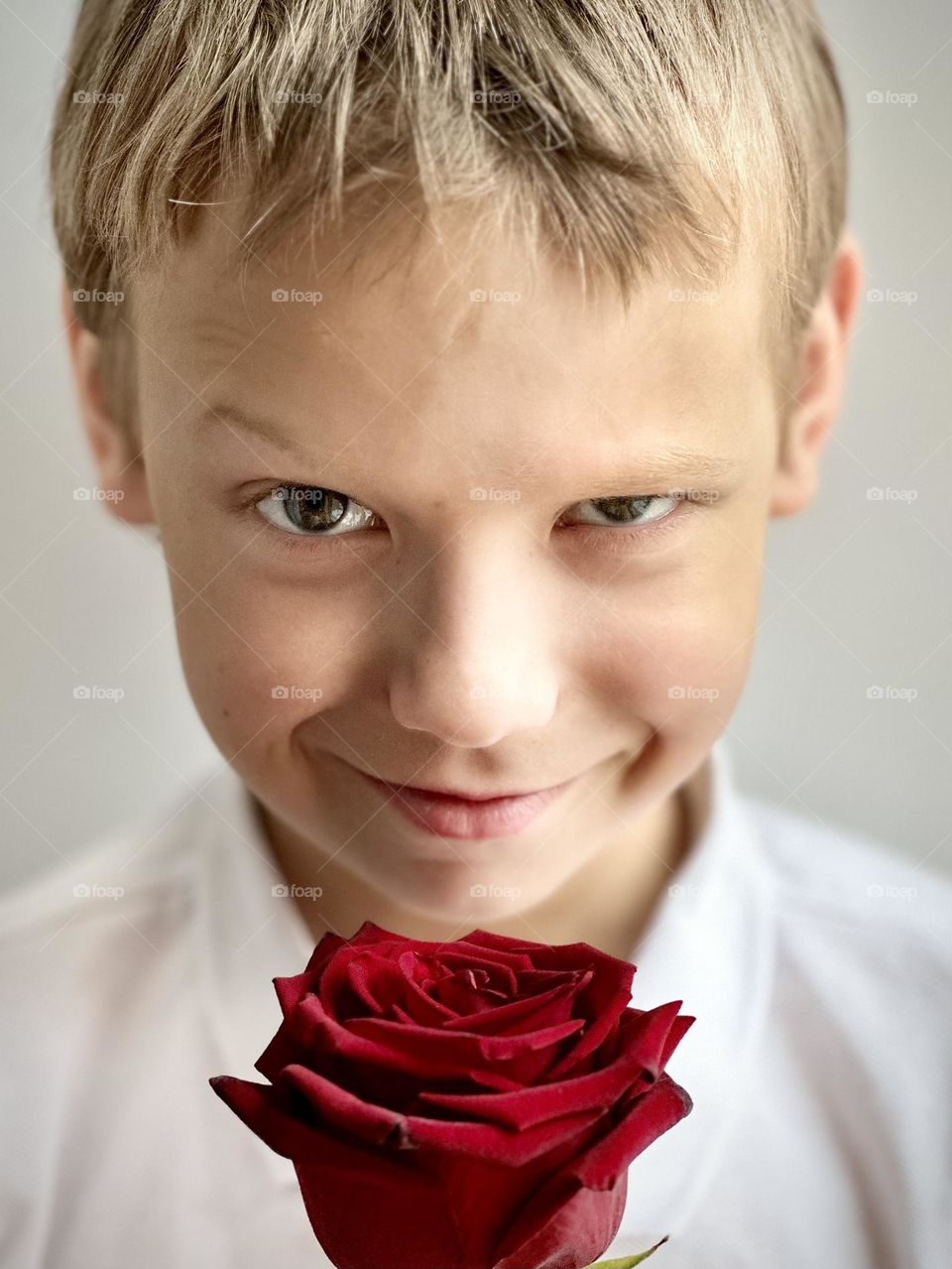 smiling boy with a rose 