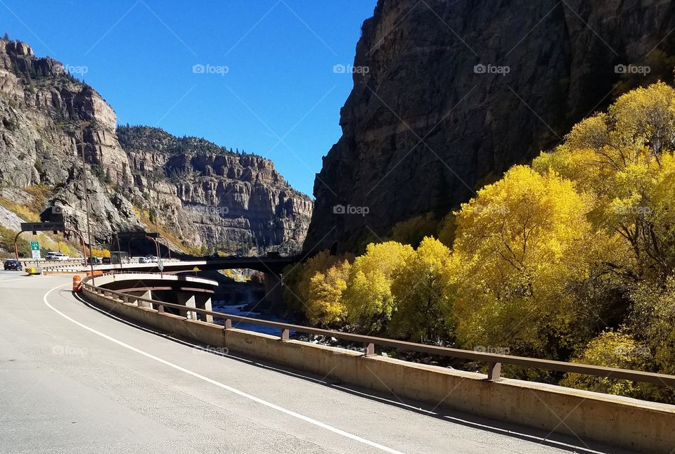 road going through beautiful Arizona mountains and beautiful yellow trees