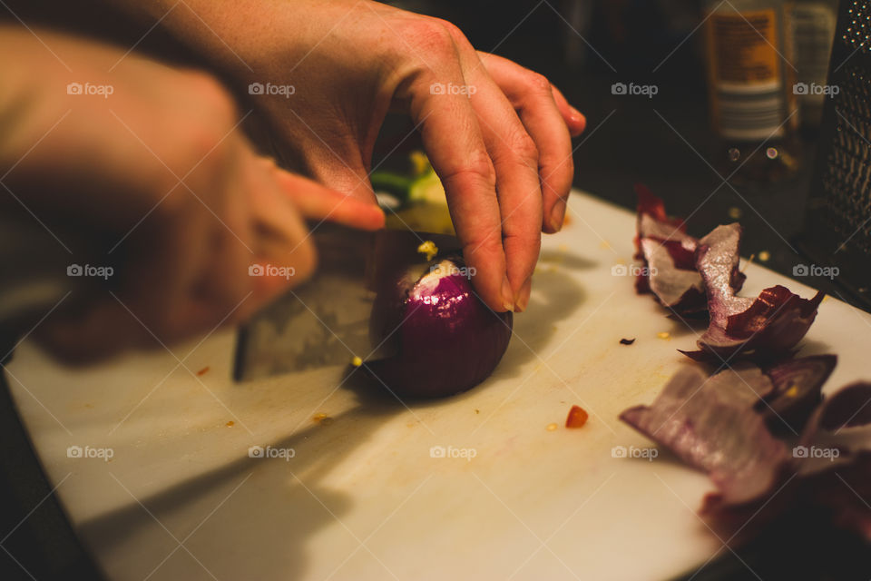 A person chopping onion