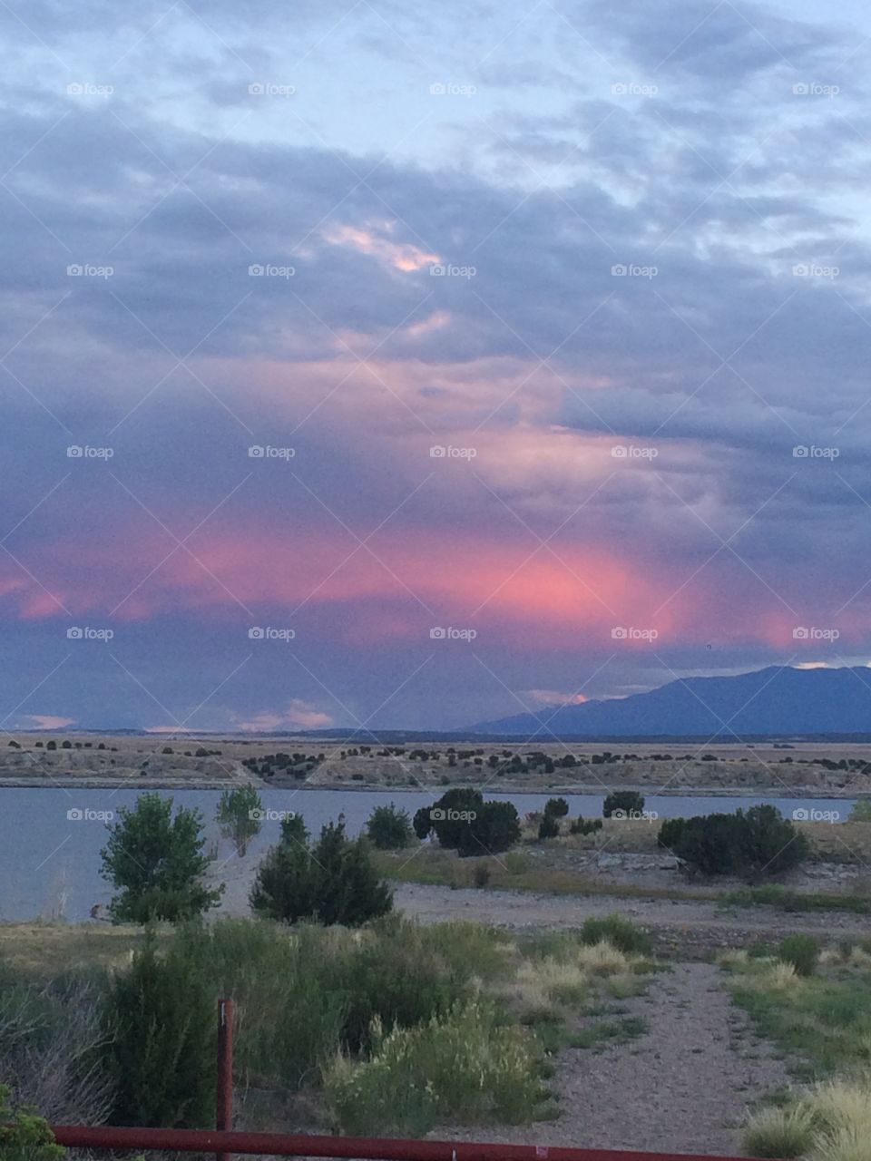 Pink and blue sunset view with mountain and lake in Colorado
