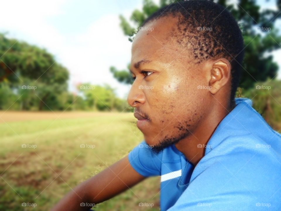 young man sitting outside