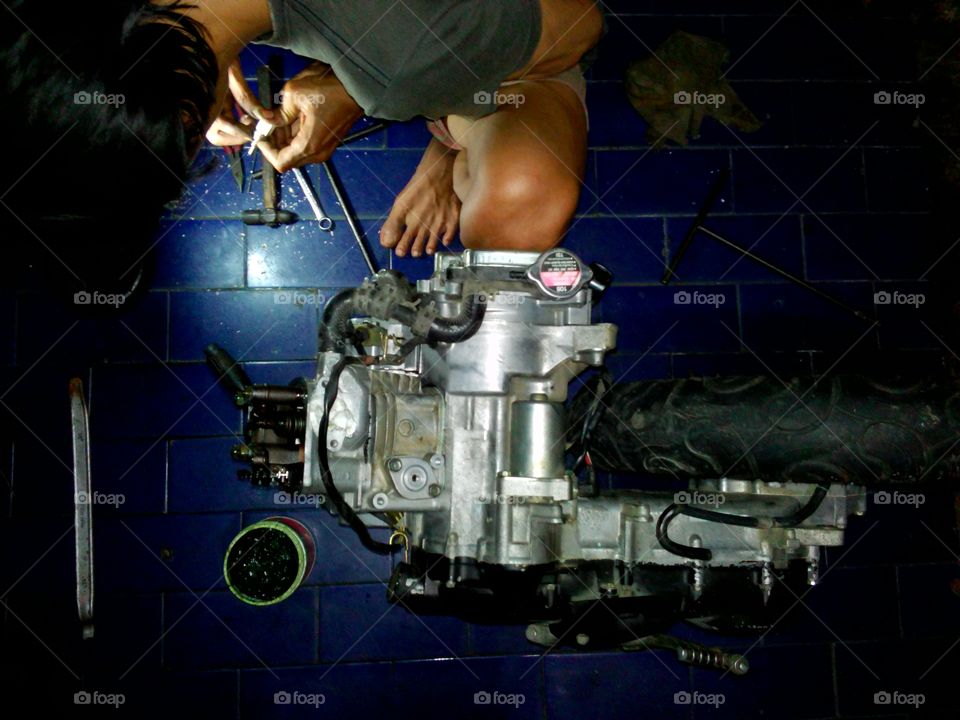 a mechanic repairing motorcycle