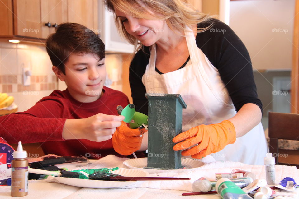 Mom and son working on arts and crafts together 