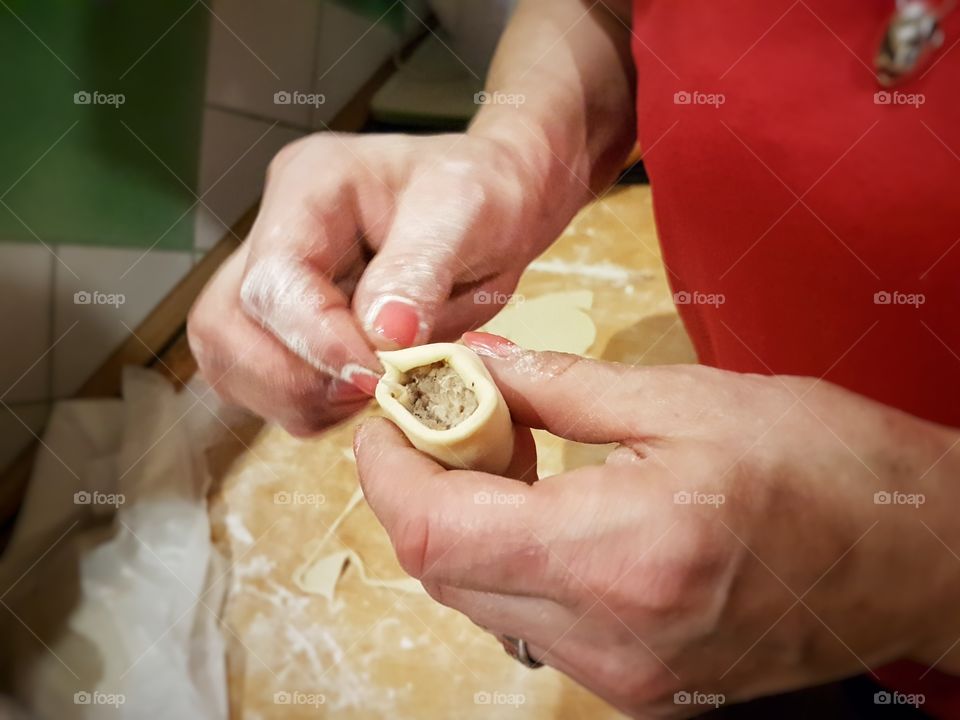 Close-up of person making piegori