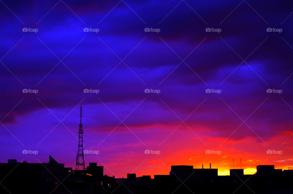 Silhouette of cityscape against sunset sky in Berlin, Germany.