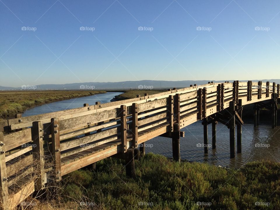 Wooden Foot Bridge over a meandering river