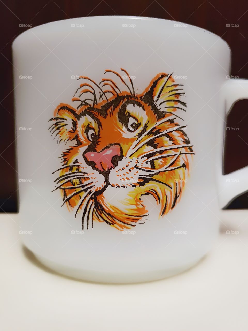 A vintage Fire-King tiger mug.