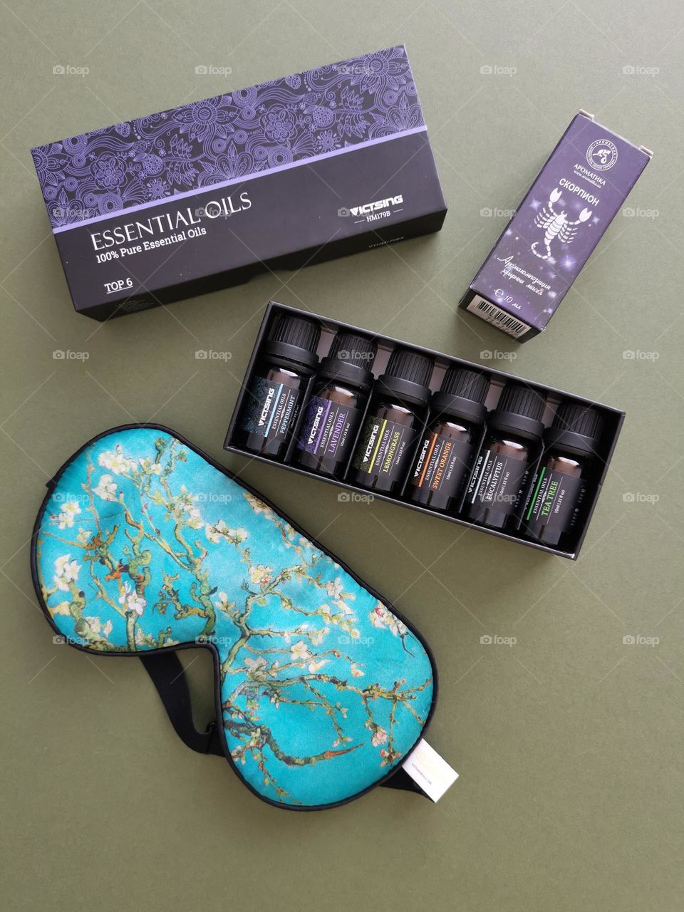 Flatlay with essential oils set and beautiful silk eye mask. Great gift for loved ones. Romantic and relaxing set...