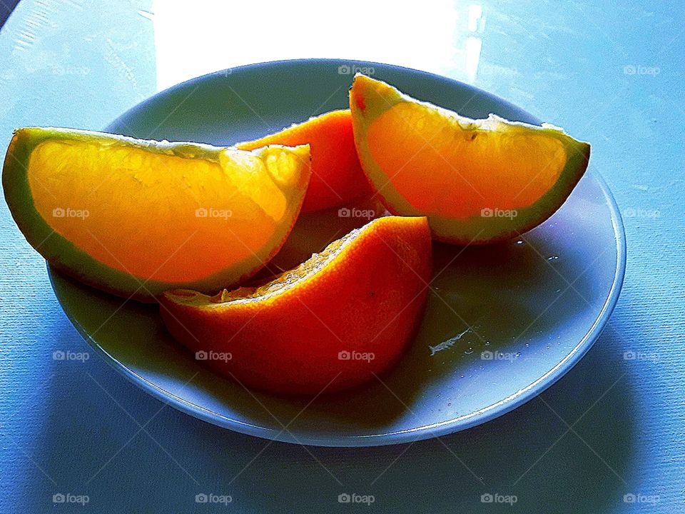 sliced ​​orange on a white saucer