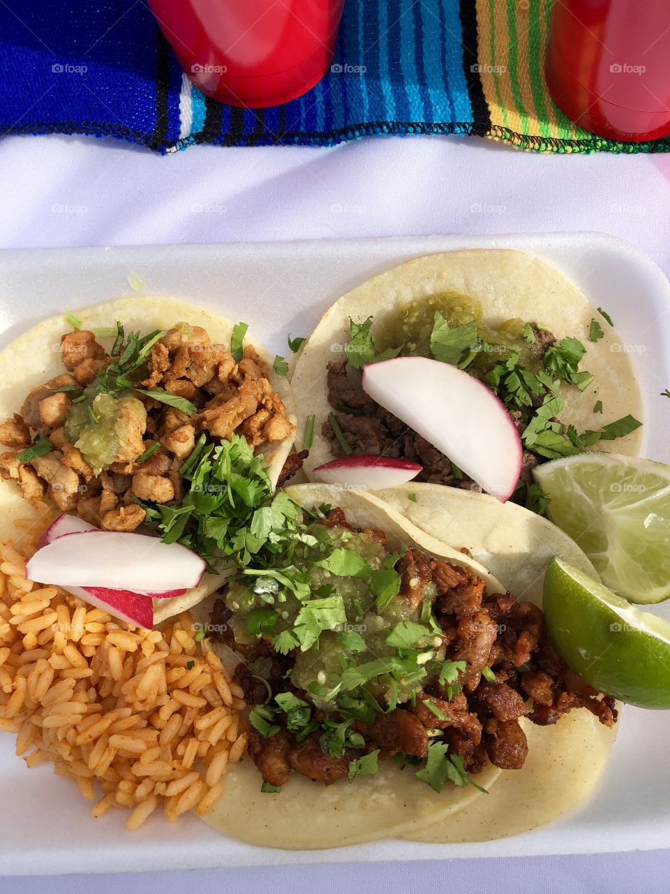 Plate of tacos- chicken, carne asada, and carnitas 