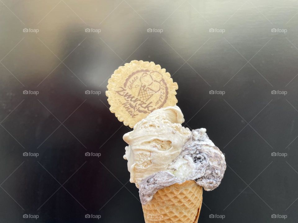 Delicious ice cream in a cone with the flavor of salted caramel and stracciatella.