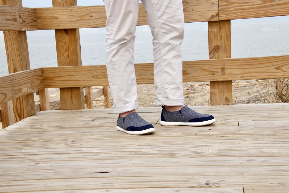 Man wearing Isotoner shoes on boardwalk 