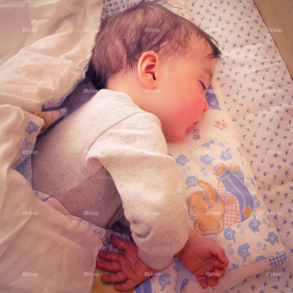 Baby boy sleeping in his bed