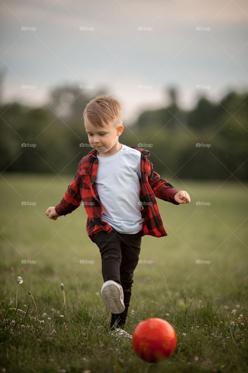 Little boy playing in soccer in a park 