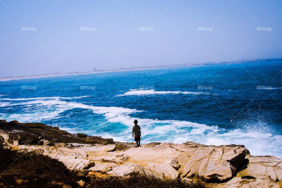Child standing on rock
