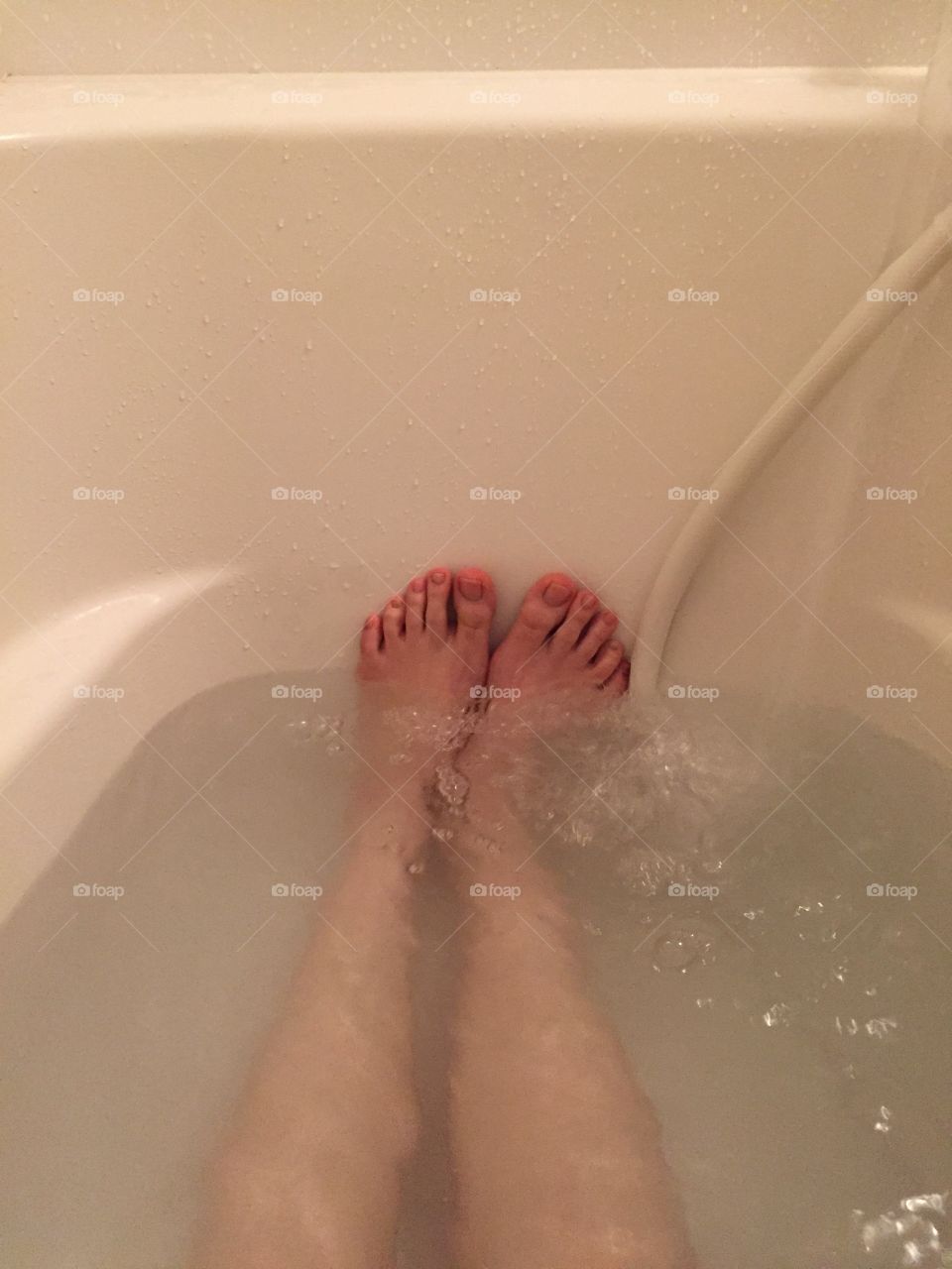 Closeup of woman's feet covered with bath great for any use.