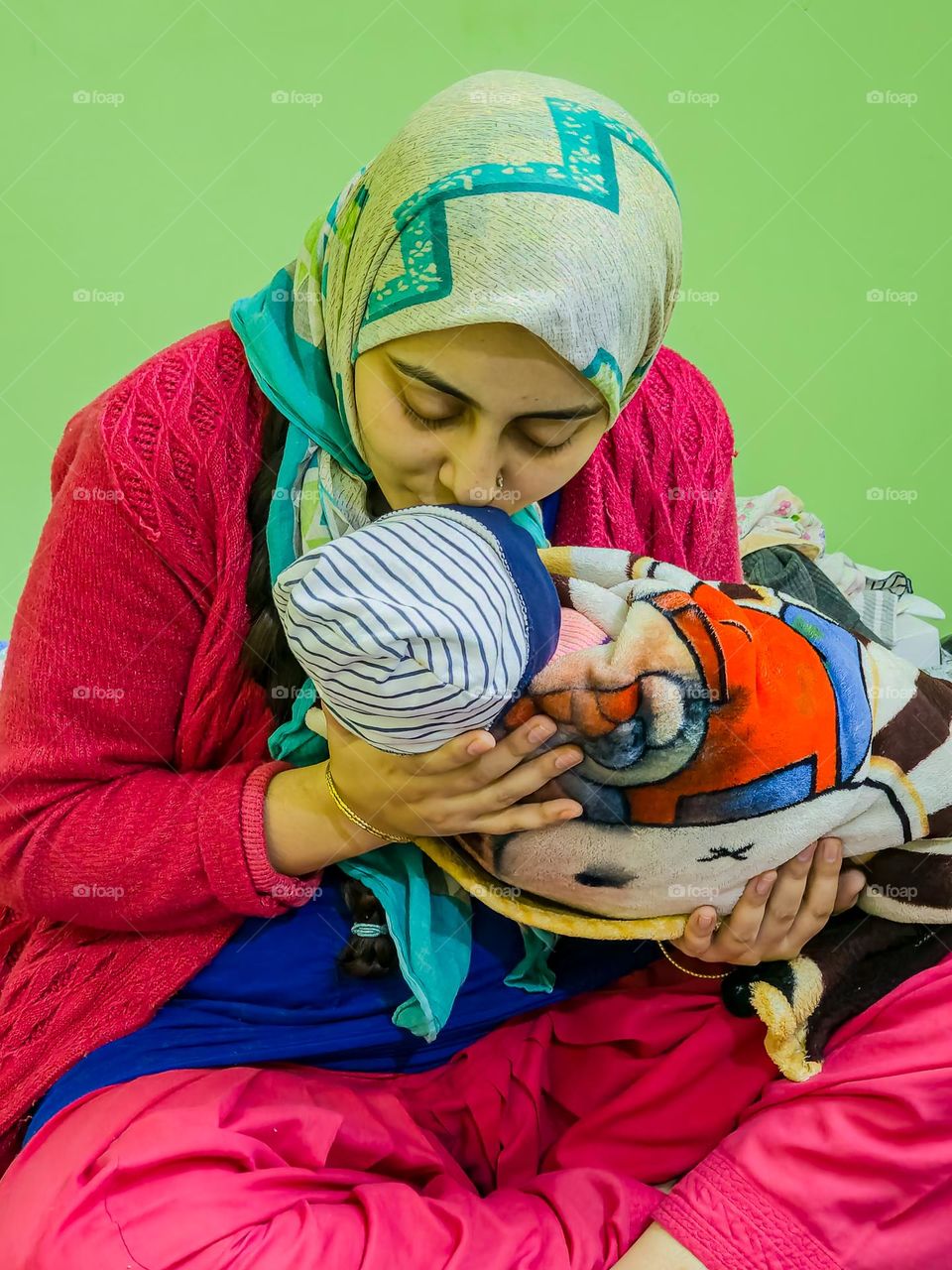 Mother kissing her newborn baby