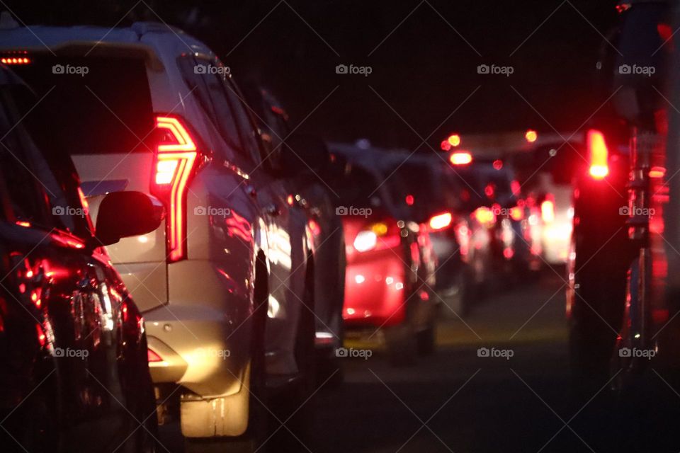 Private cars stuck in a traffic jam commuting at night.