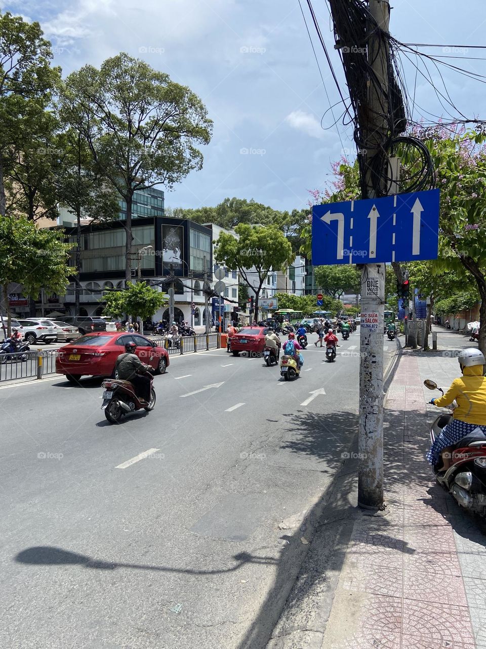Three lane split road sign in city Vietnam 